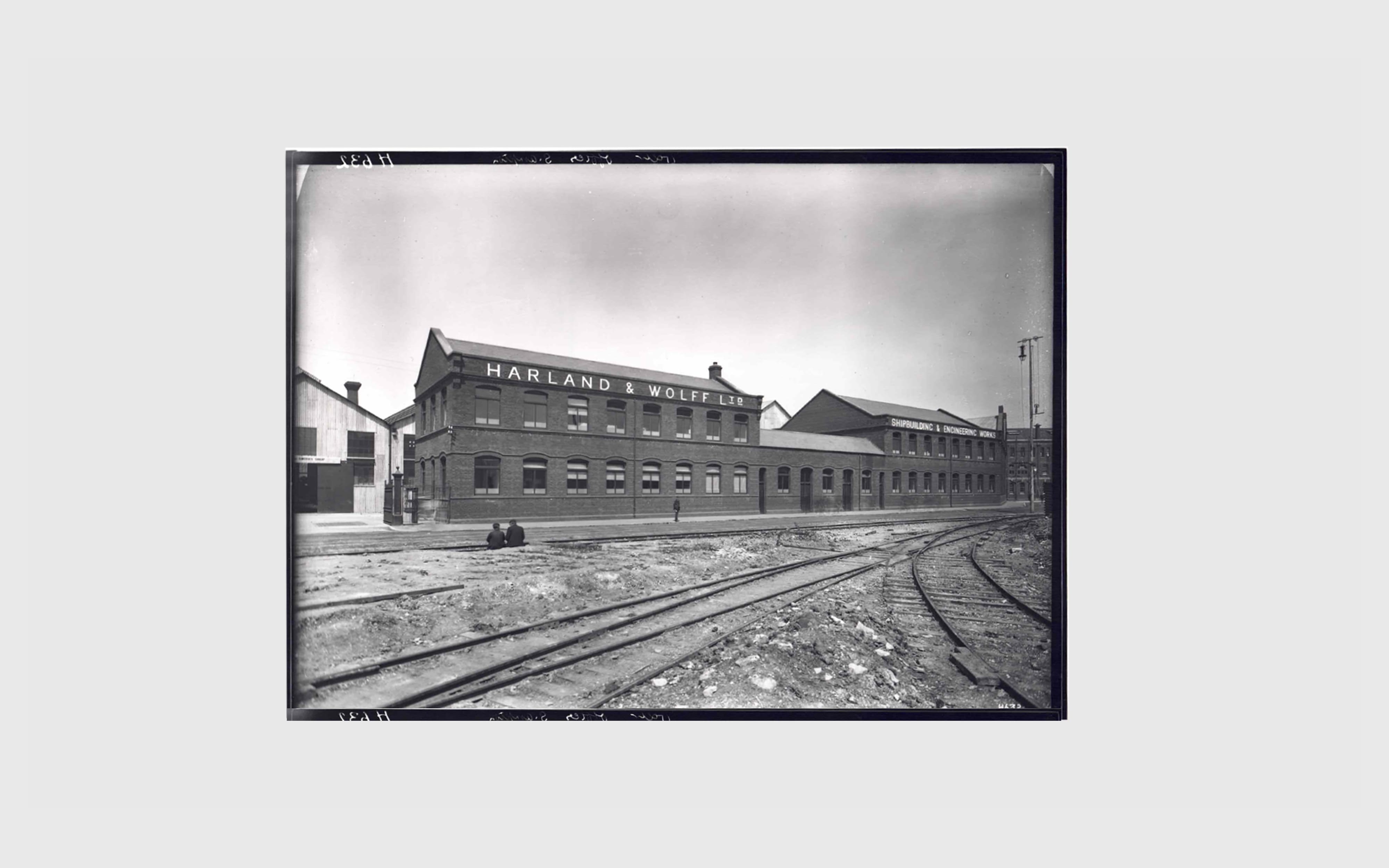 Harland & Wolff archive image showing exterior buildings in the late 1800, early 1900s with railway line in foreground