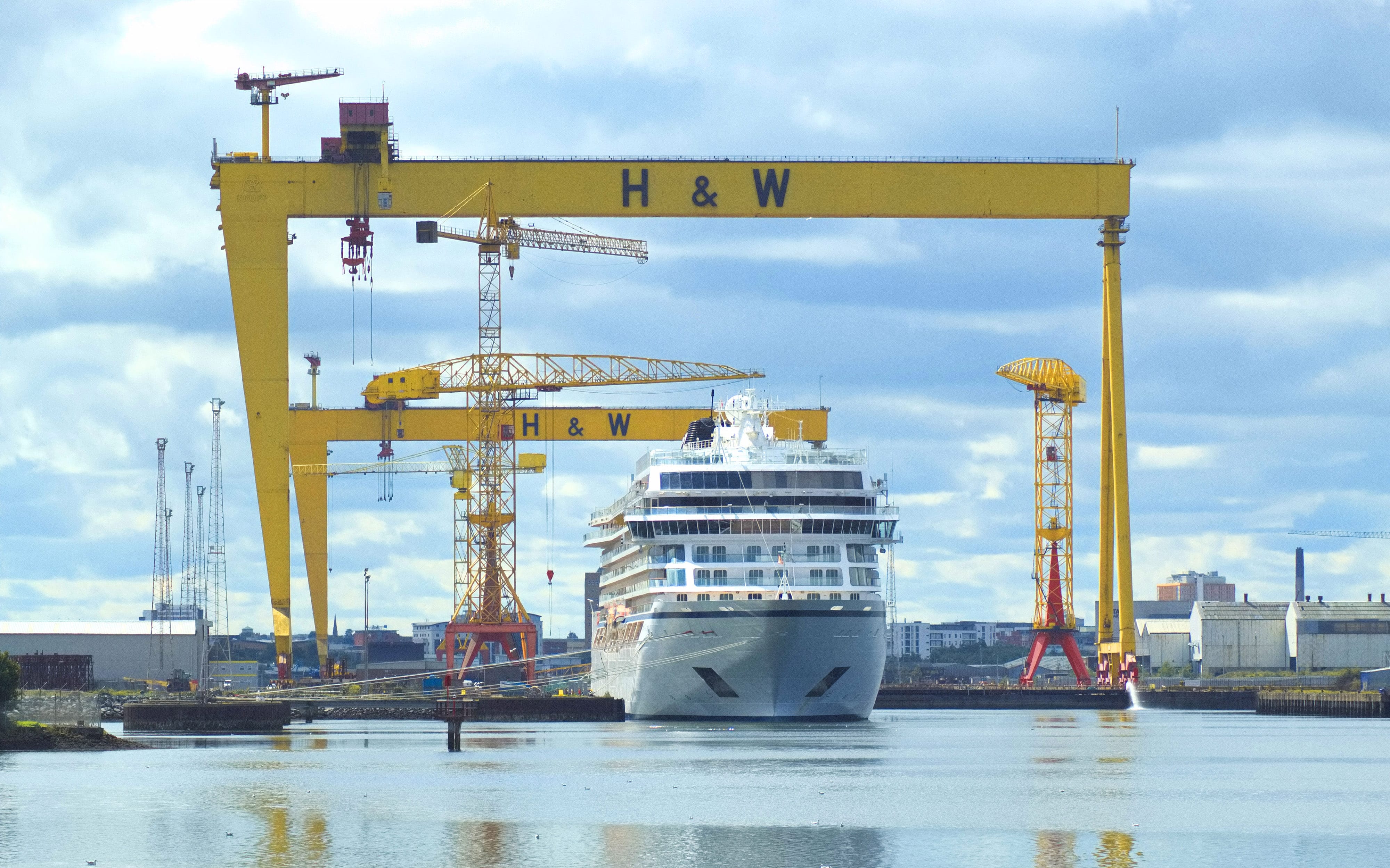 Harland & Wolff cranes in Belfast skyline with cruise ship beneath it in the water