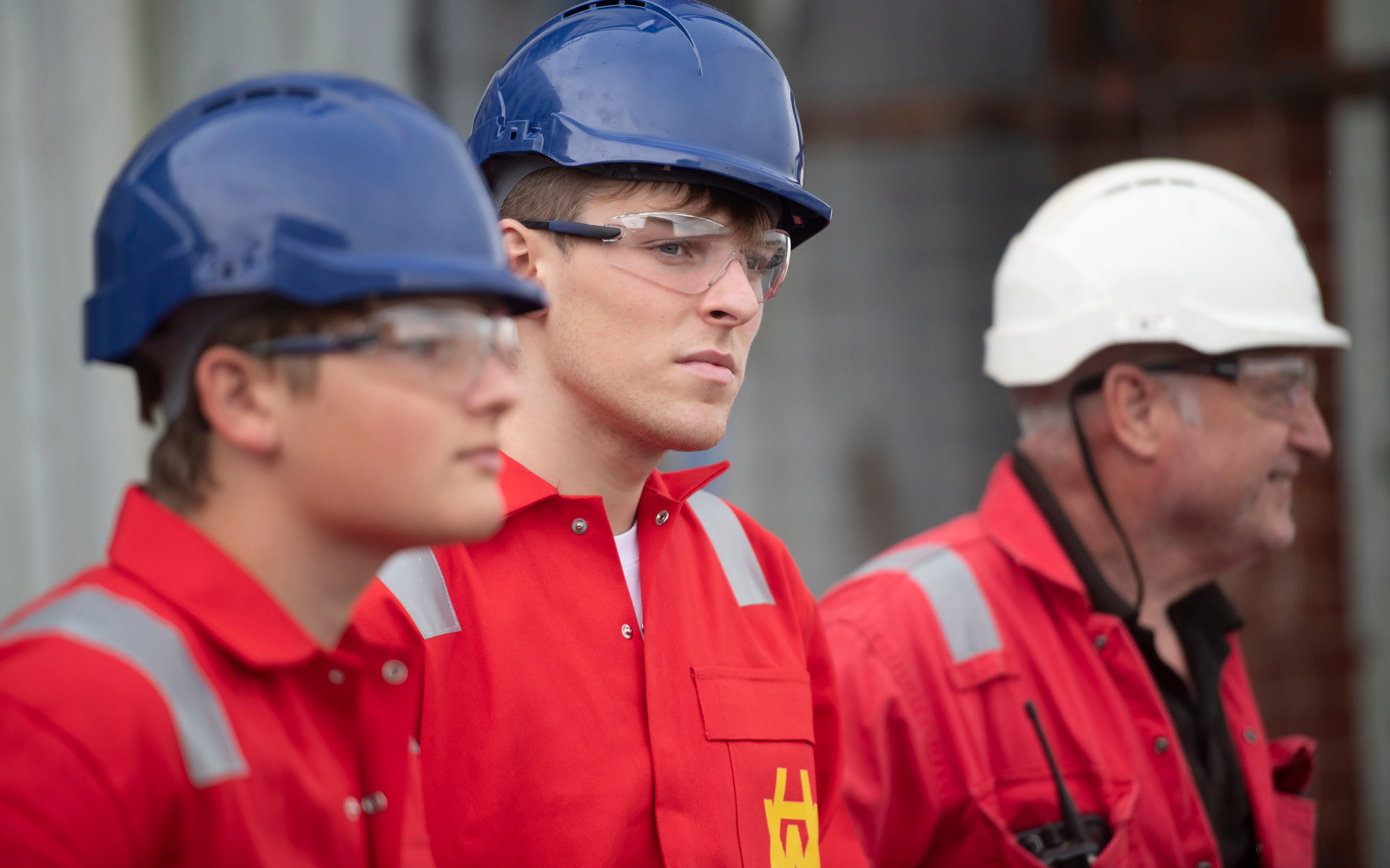 Harland & Wolff workers and apprentices wearing PPE and showing yellow H&W monogram